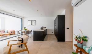 a living room with a kitchen and a dining room at Casa di Chibi Chibi - Brand new apartment with pool close to the beach in Jan Thiel