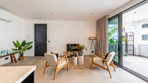 a living room with a table and chairs at Casa di Chibi Chibi - Brand new apartment with pool close to the beach in Jan Thiel +31 photos