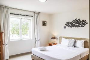 a bedroom with two beds and a window at Azure Haven in Willemstad