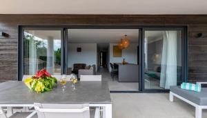 a dining room with a table with wine glasses at Dushi Breeze in Blue Bay +20 photos