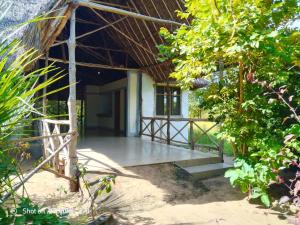 an outside view of a building with a porch at Malombo Selous Forest Camp in Kwangwazi