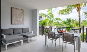a living room with a couch and a table and chairs at The Breeze Escape in Blue Bay