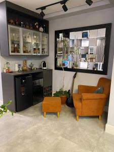 a living room with a couch and a chair at Belíssimo apartamento em Porto Alegre! in Porto Alegre