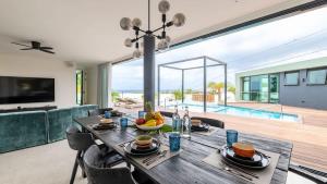a dining table in a living room with a view of the ocean at Villa Sea View Luxury in Willemstad +66 photos