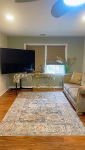 a living room with a couch and a flat screen tv at Enjoy with luxury house in North Haledon +18 photos