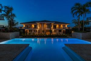 a house with a swimming pool at night at The Breeze 50 in Willemstad +26 photos
