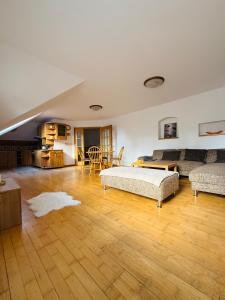 a large living room with a bed and a couch at Srdce Mesta V Podkroví - slnečný apartmán s balkónom in Stará Turá