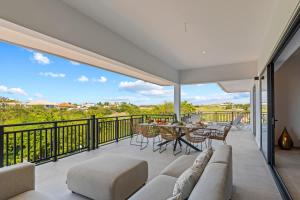 a living room with a couch and a table on a balcony at Azure Penthouse in Willemstad