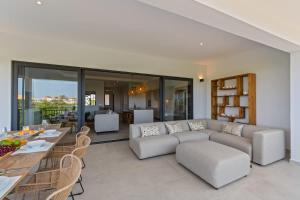 a living room with a couch and a table at Azure Penthouse in Willemstad