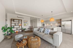 a living room with a couch and a kitchen at Azure Penthouse in Willemstad +64 photos