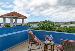a balcony with two chairs and a gazebo at Villa Star Beach - Private pool and sea view! in Willemstad +80 photos