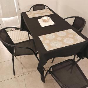 a black table with two chairs and a plate on it at Kalma in Villa Elisa +5 photos
