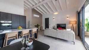 a kitchen and living room with a couch and a table at The Wave - Excellently located Penthouse with pool in Jan Thiel