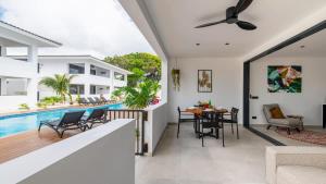 a house with a swimming pool and a dining room at Palm Suite - Newly constructed poolside apartment just minutes from the beach in Jan Thiel +41 photos