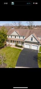 a large white house with a driveway in front of it at Enjoy with luxury house in North Haledon