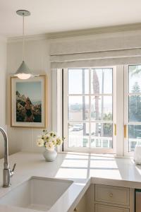 a kitchen with a sink and a large window at Bay Shores Peninsula Hotel in Newport Beach