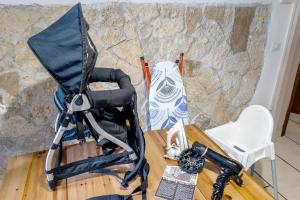 a chair sitting on a table next to a stone wall at Appartamento Tivoli Train Station in Tivoli