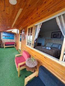 a bedroom with a bed and a couch and a table at Bangaló Buzio Relax in Portal +61 photos