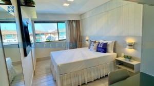 a bedroom with a bed and a large window at La Fleur Collection Vacation Homes - Residence & Resort in Porto De Galinhas +254 photos