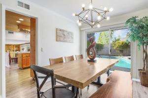 a dining room with a wooden table and chairs at Charming Villa with Backyard Oasis Close to Beach in Laguna Hills
