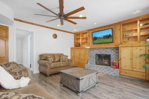 a living room with a couch and a fireplace at Charming Villa with Backyard Oasis Close to Beach in Laguna Hills +24 photos