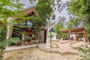 a house in the middle of a forest at Xtambaa Selva in Tulum