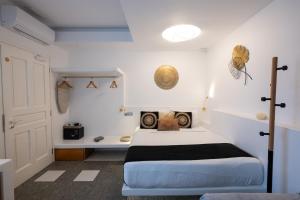a bedroom with a white bed and a white door at Mykonos Double Luxury Mini Suites-With External Hot spa Adults only in Ano Mera +96 photos