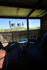 a porch with chairs and a table and a house at Loft de Mar in José Ignacio