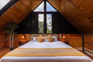 a bedroom with a bed with a large window at Xtambaa Selva in Tulum