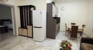 a kitchen with a white refrigerator and a table at Flower Garden Rest House in Yerevan