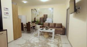 a living room with a couch and a table at Flower Garden Rest House in Yerevan
