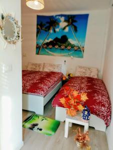 a bedroom with two beds and a picture on the wall at La perla di Maria in Grado