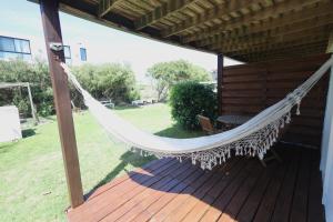 a hammock on a porch of a house at Loft de Mar in José Ignacio +6 photos
