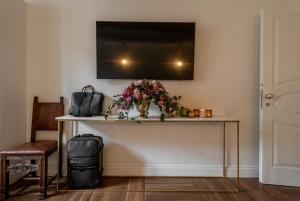 a table with a vase of flowers on a wall at termini camera in Rome