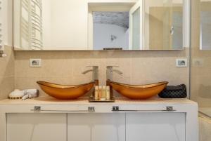a bathroom with two brown sinks on a counter at termini camera in Rome