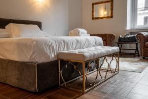 a bedroom with a large bed with a bench next to it at termini camera in Rome