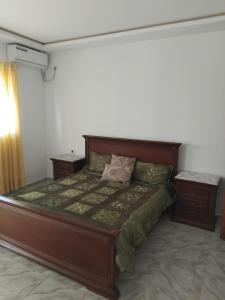 a bedroom with a bed and a night stand at Appartement s 1 centre ville zarzis in Zarzis