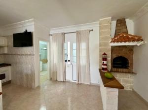 a living room with a fireplace and a tv at Casa Alba in La Mareta