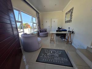 a living room with a sign for a bonsidian house at 23 on Camden Road Guesthouse in East London