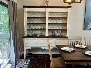a dining room with a white hutch and a table at Cozy Mountain Song- Massanutten Mountain in McGaheysville