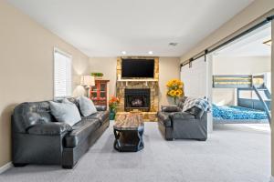 a living room with two leather couches and a fireplace at Cozy Mountain Song- Massanutten Mountain in Hopkins Spring