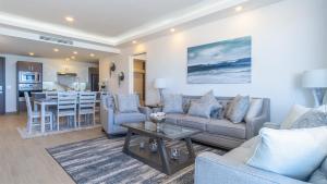 a living room with a couch and a table at Encantame Towers Viento 304 in Playa Encanto