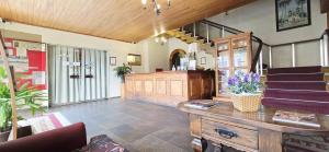 a lobby of a building with a staircase and a room at Hotel Ponte Real in São João del Rei +70 photos