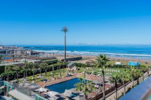 a view of a beach with a pool and palm trees at C07- Pestana - Luxury Hotel Flat - Terrace - Pool in Casablanca