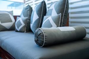 a bed with blue and white pillows on it at C07- Pestana - Luxury Hotel Flat - Terrace - Pool in Casablanca +41 photos