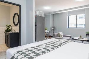 a bedroom with a large bed and a table at City Oasis Suite Cape Town in Cape Town