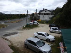 a group of cars parked on the side of a road at Pension Meson Paz in Puentedeume