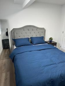 a bedroom with a blue bed with blue pillows at Guest Suite with Private Entry in Calgary in Calgary