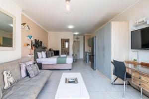 a living room with a couch and a bed at City Light & Mountain Sight in Cape Town