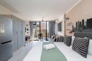 a living room with a large couch and a living room with a couch at City Light & Mountain Sight in Cape Town